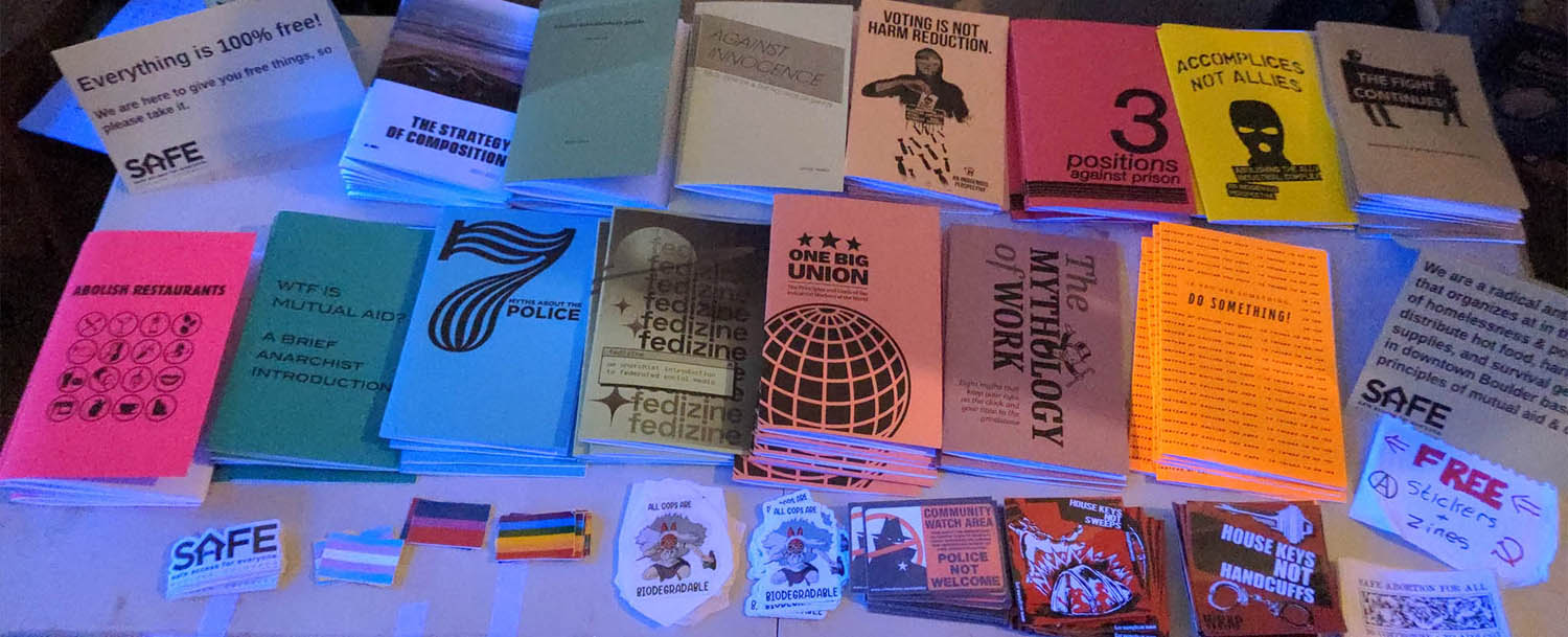 A table covered in radical zines and stickers.